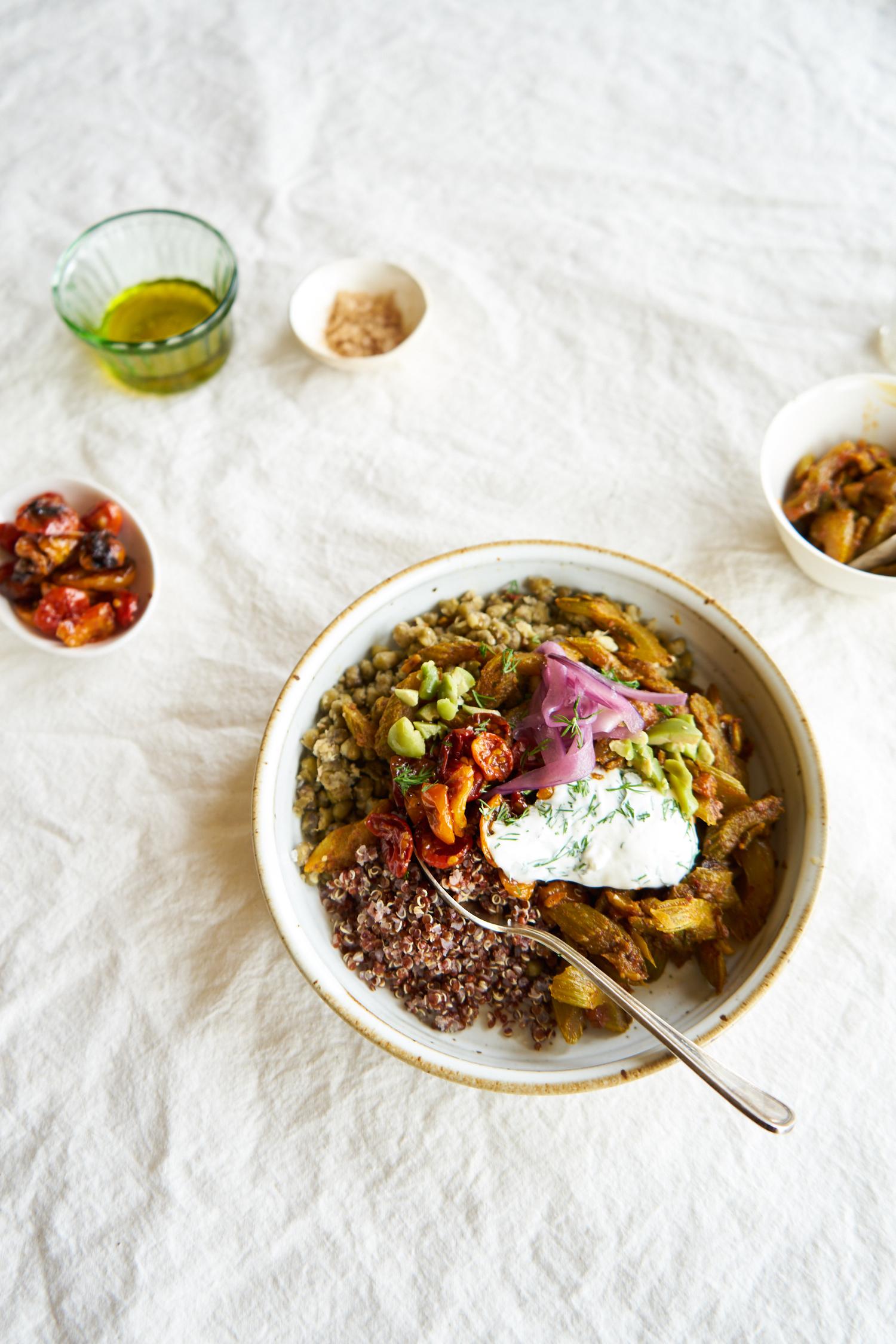 quinoa power bowl topped with tomatoes, yogurt, onions