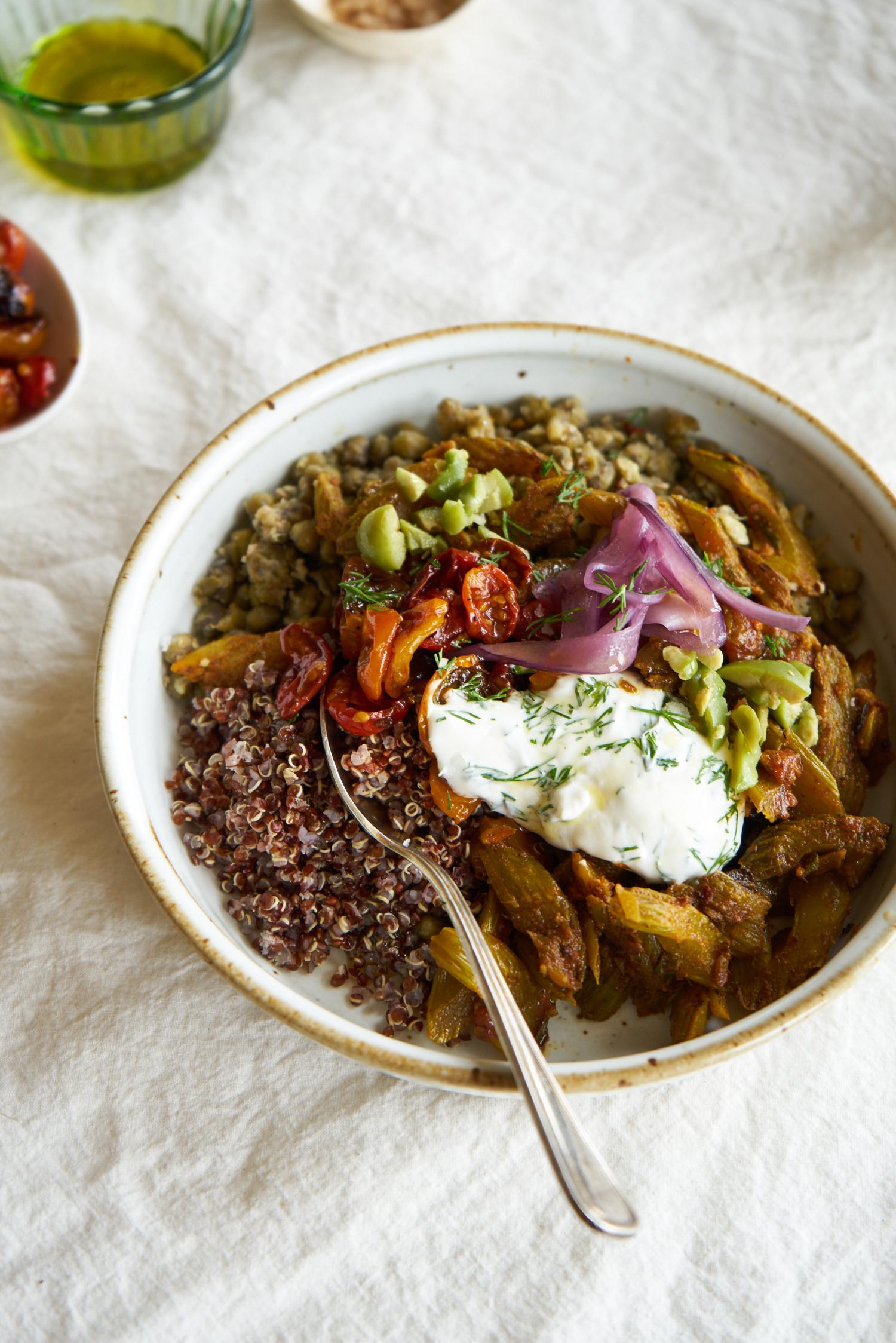 quinoa power bowl topped with tomatoes, yogurt, onions