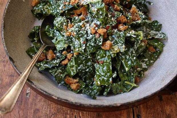 kale salad topped with breadcrumbs in a large bowl