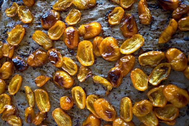 yellow cherry tomatoes on a baking sheet