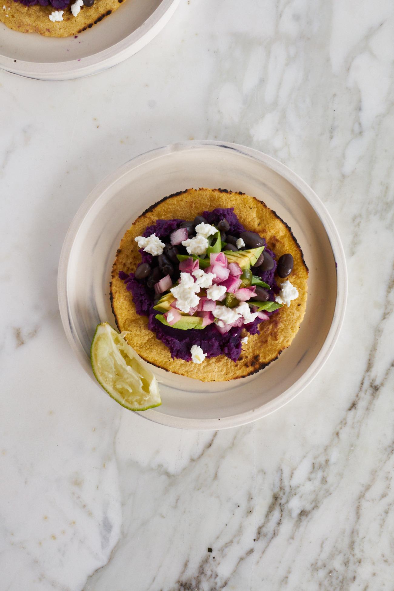 Sweet Potato Tacos on a plate with lots of toppings