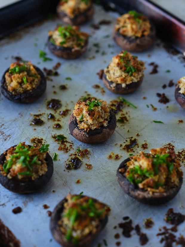 stuffed mushrooms arranged on a baking sheet after baking