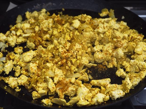 tofu scramble ingredients cooking in a skillet