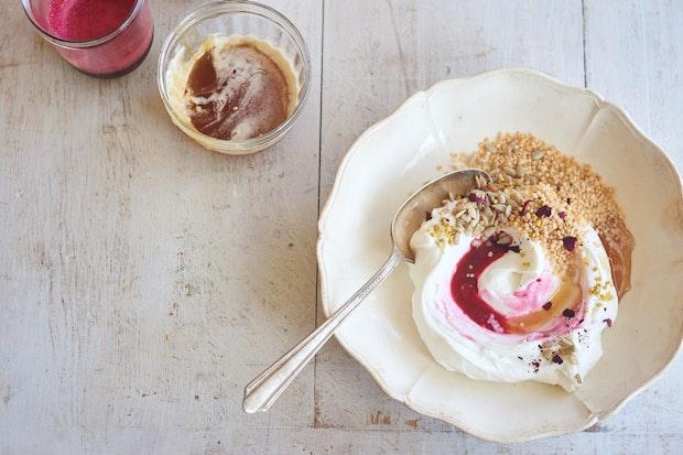 yogurt bowl topped with pomegranate juice and honey