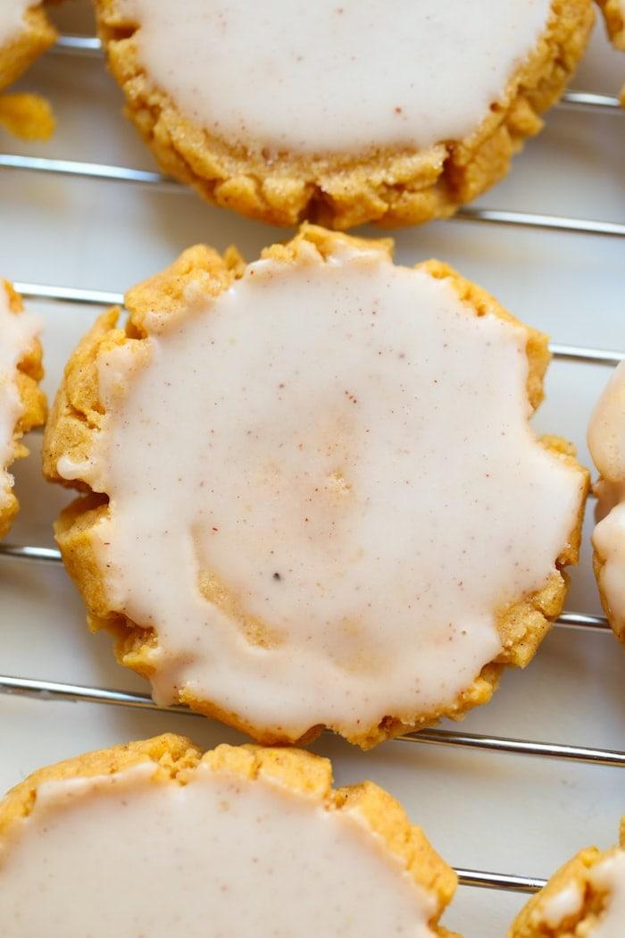 soft pumpkin cookies top down view of pumpkin sugar cookies on a cooling wrack