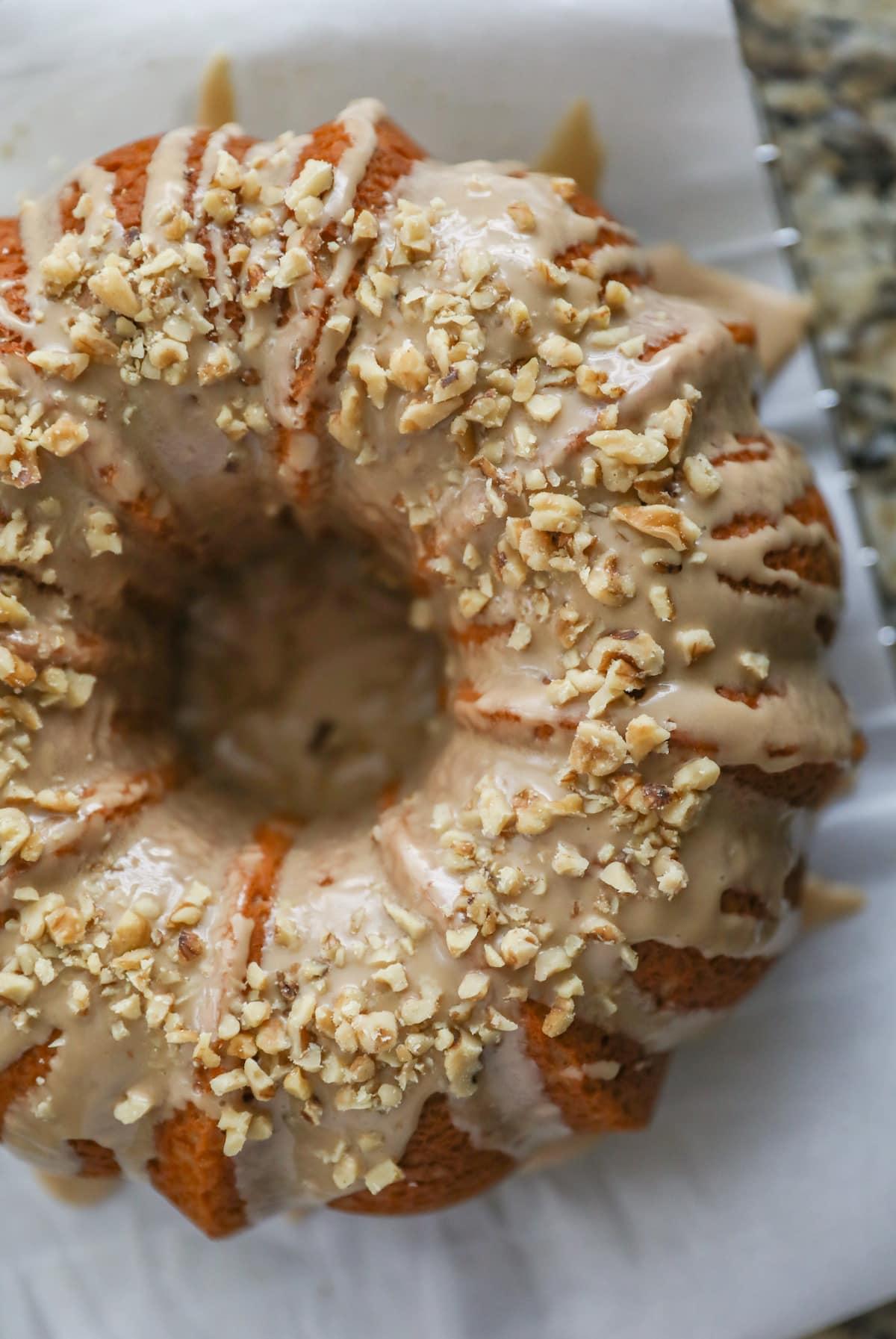 whole maple cake with icing and walnuts