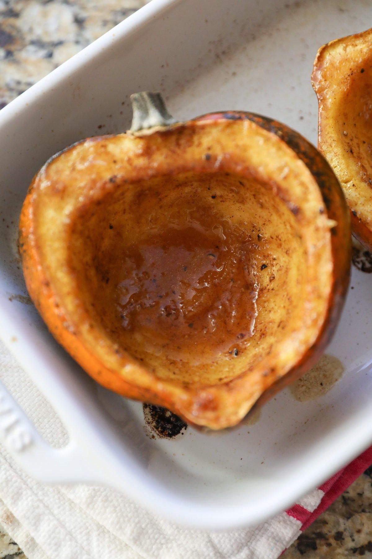 roasted acorn squash in white baking dish