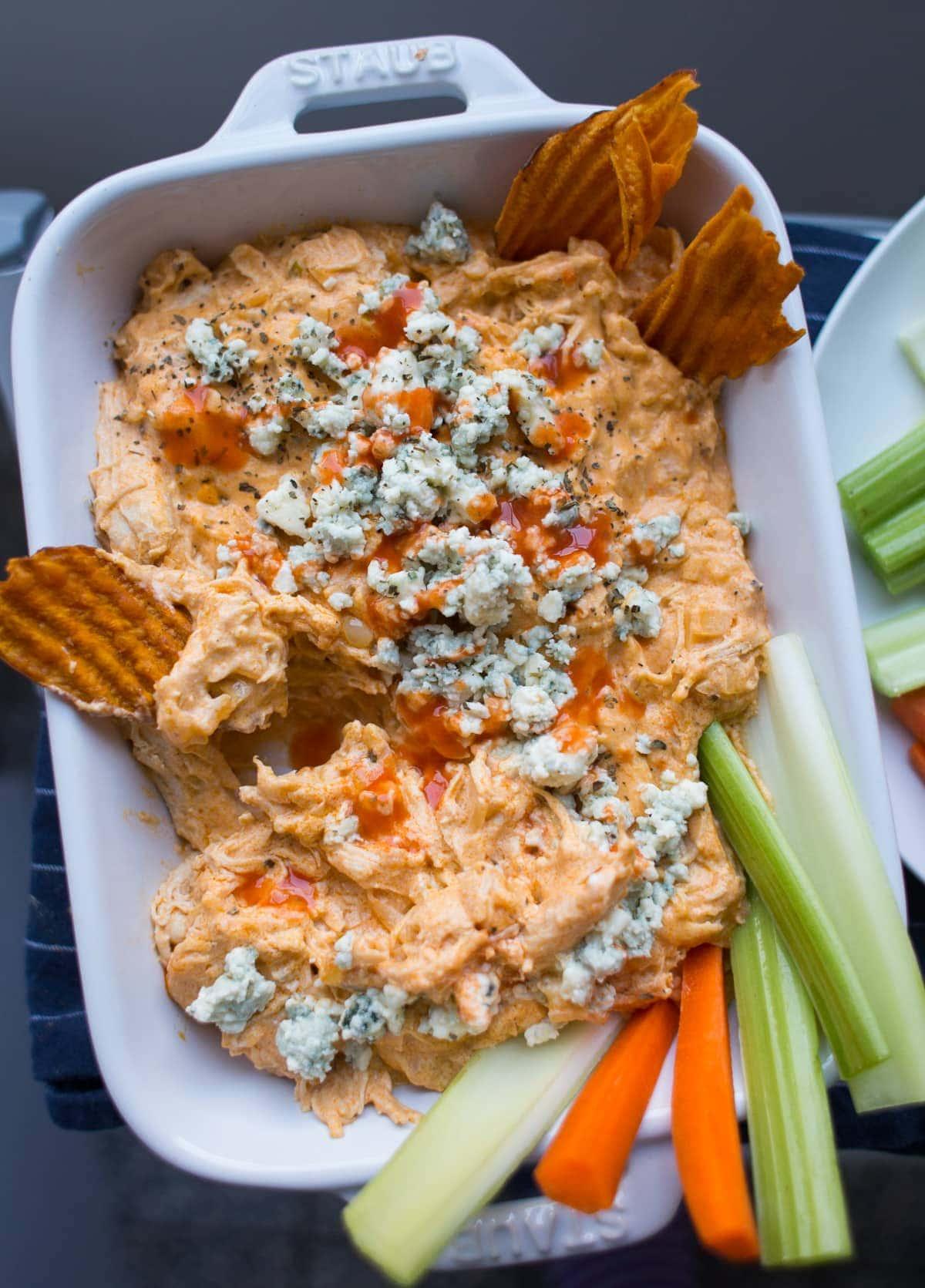 Buffalo Chicken Dip in a white casserole dish