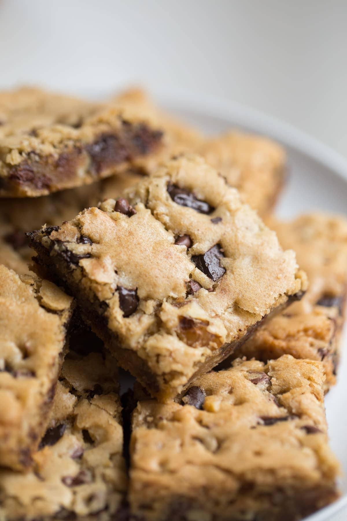 Chocolate Chip Cookie Bars stacked on top of one another on a white plate