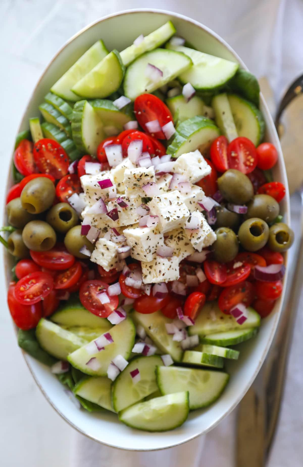 overhead shot of greek salad in oval bowl