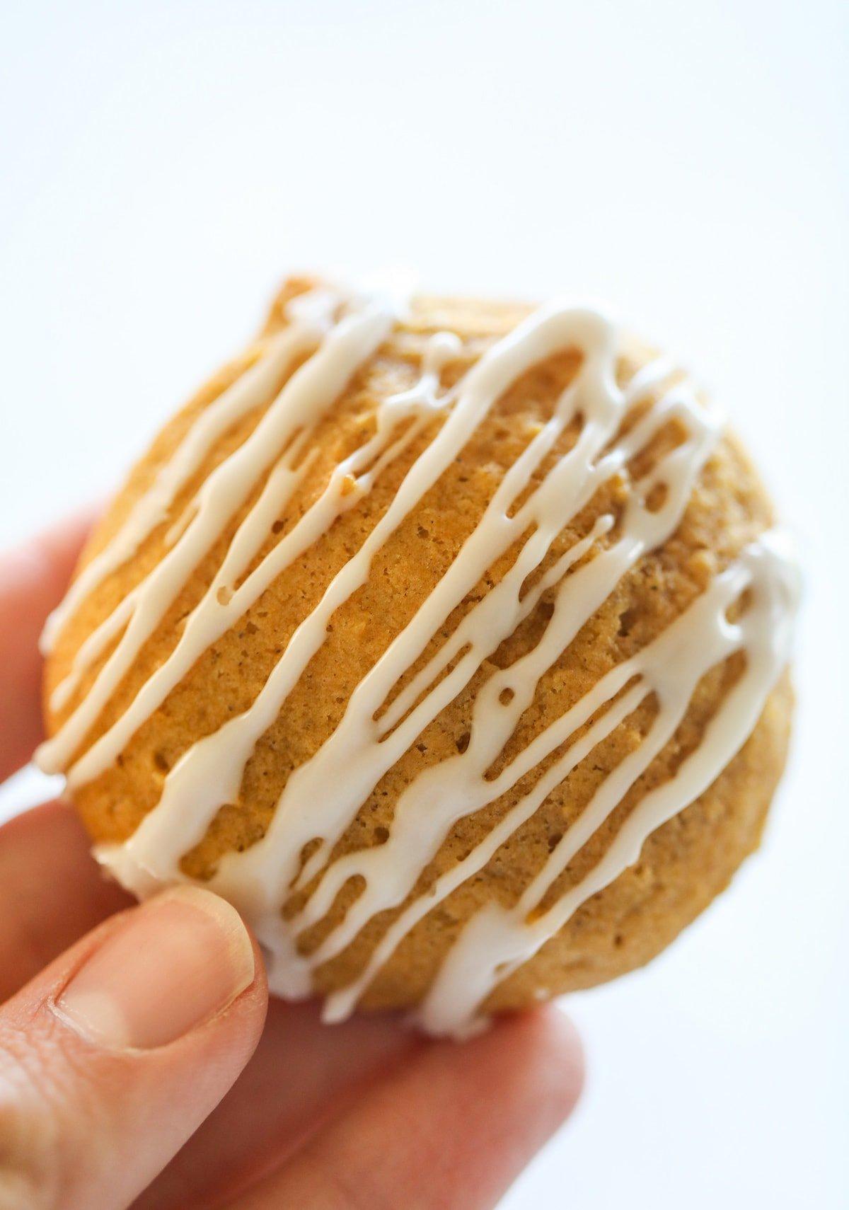 hand holding pumpkin cookie