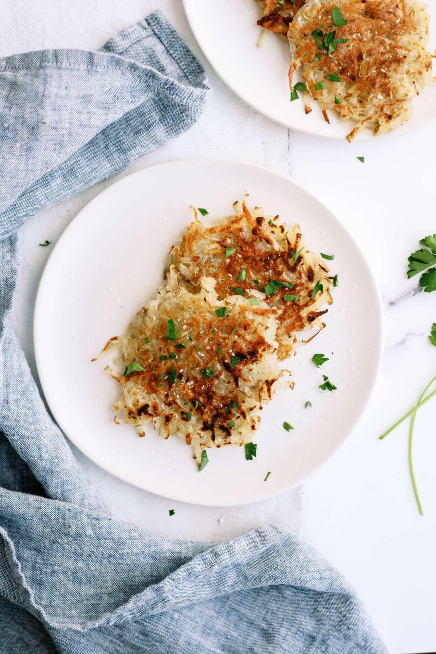 top down view of potato pancakes on a white plate