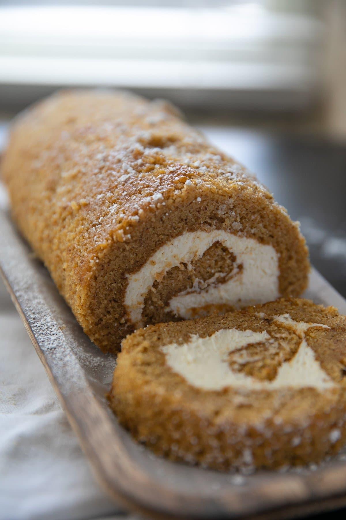 pumpkin roll cake with a slice cut