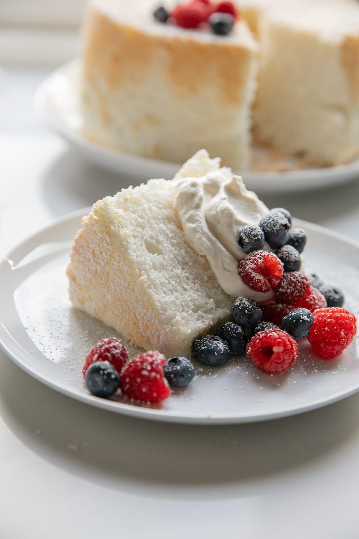 slice of angel food cake with whipped cream and berries