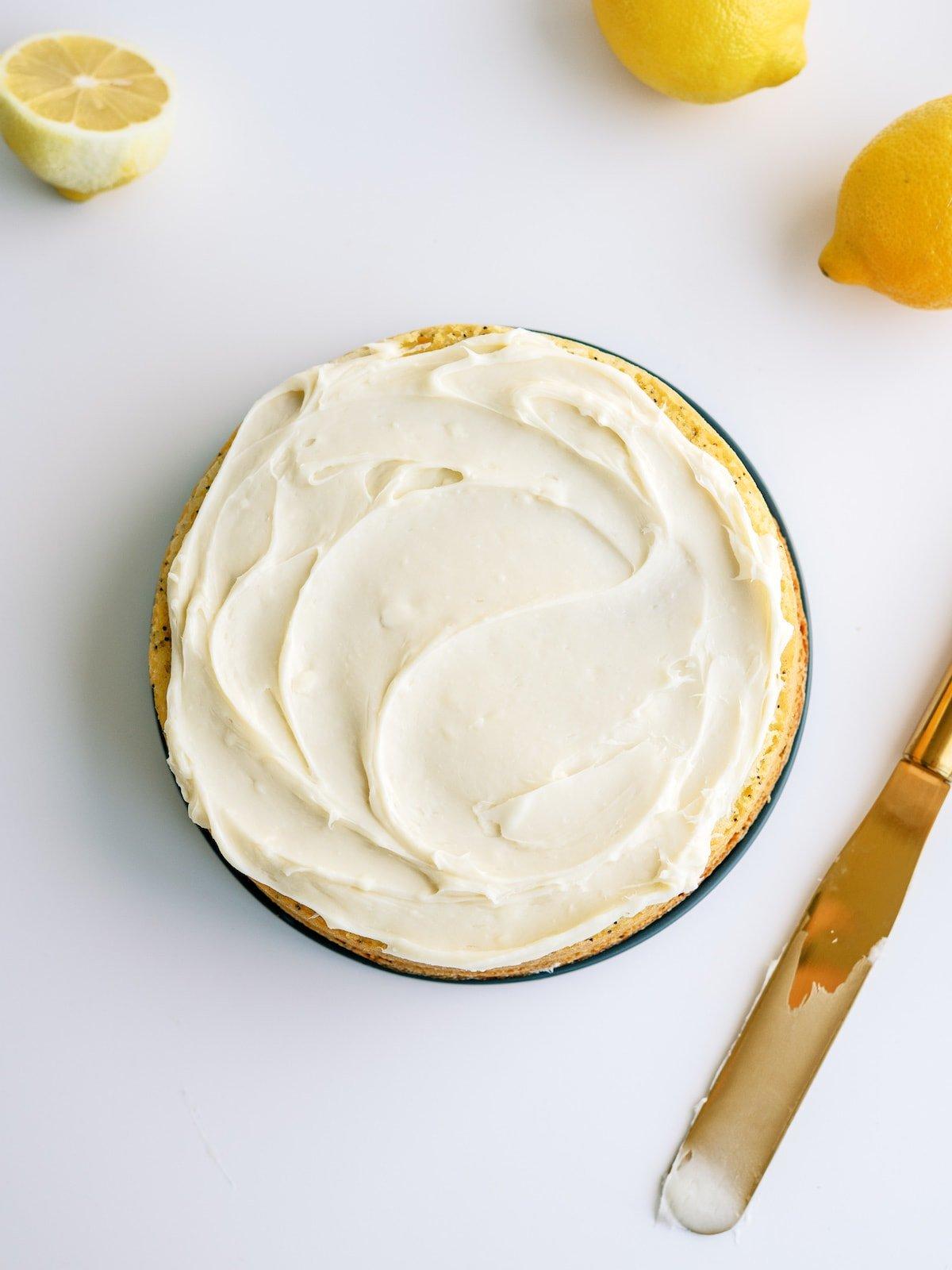 adding frosting to cake