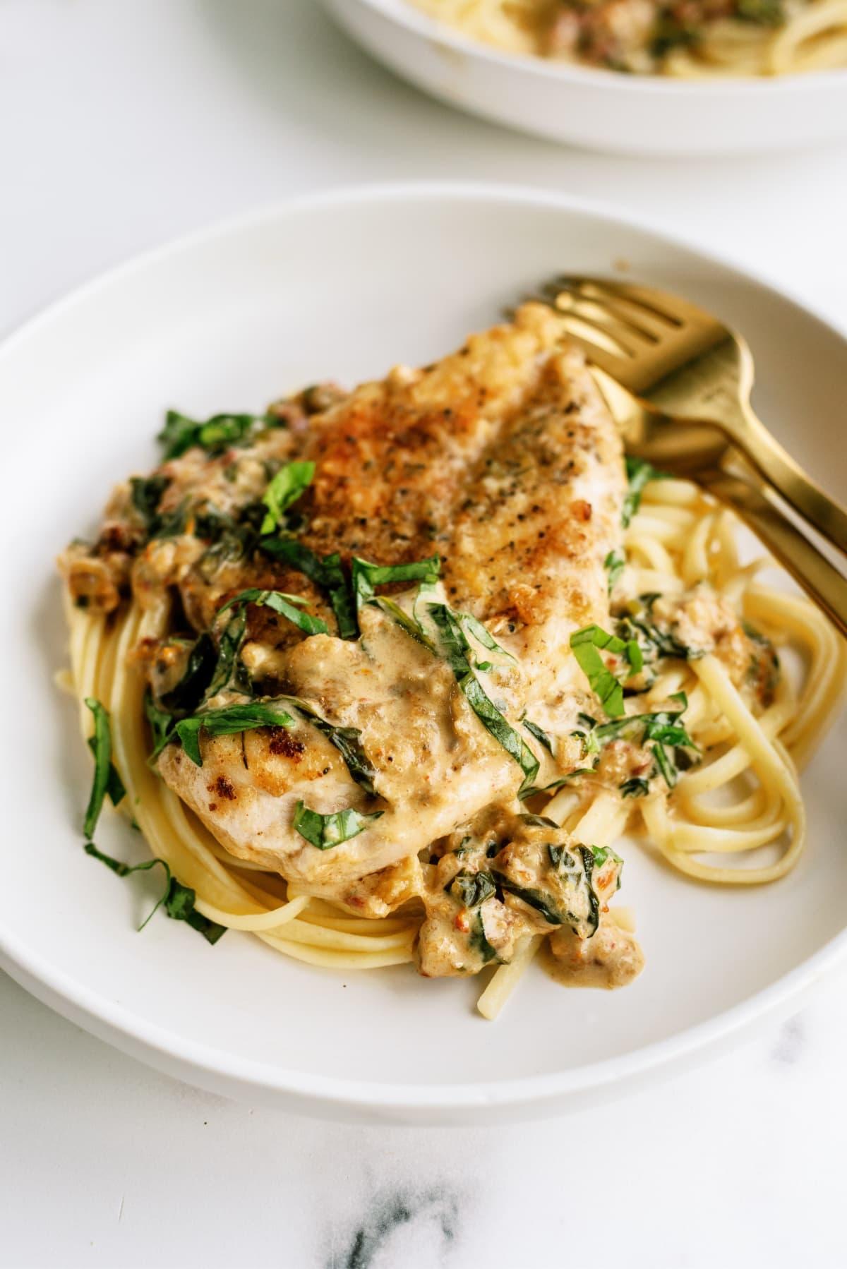 tuscan-chicken on plate with fork