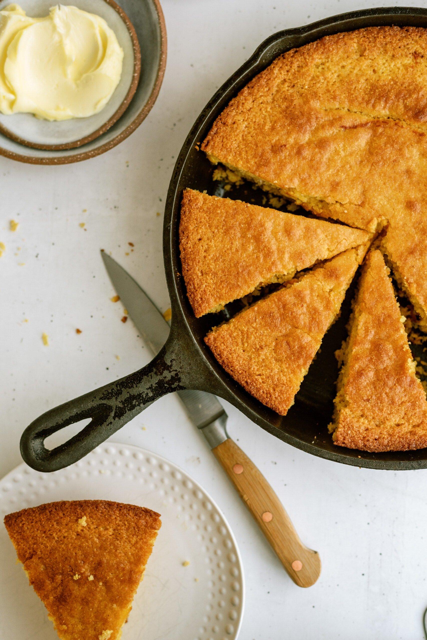 cornbread cut into pieces in cast iron skillet