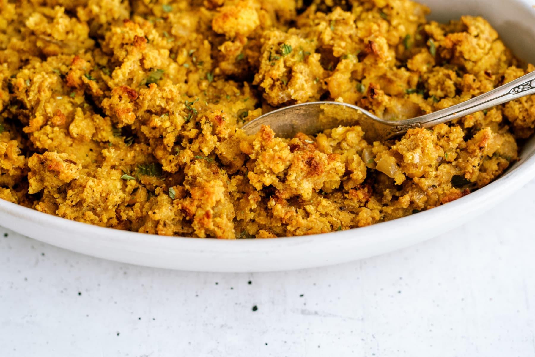 cornbread stuffing in dish with serving spoon