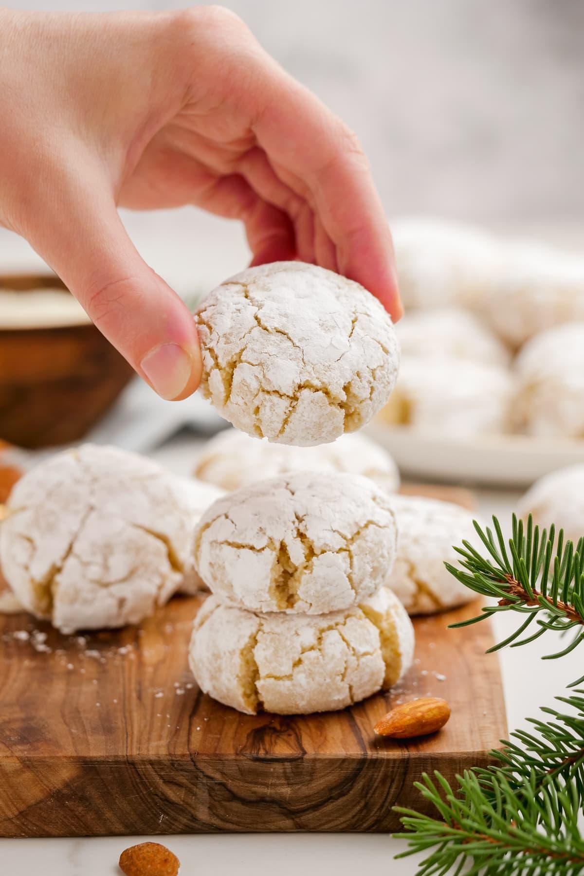 woman's hand holding amaretti cookie