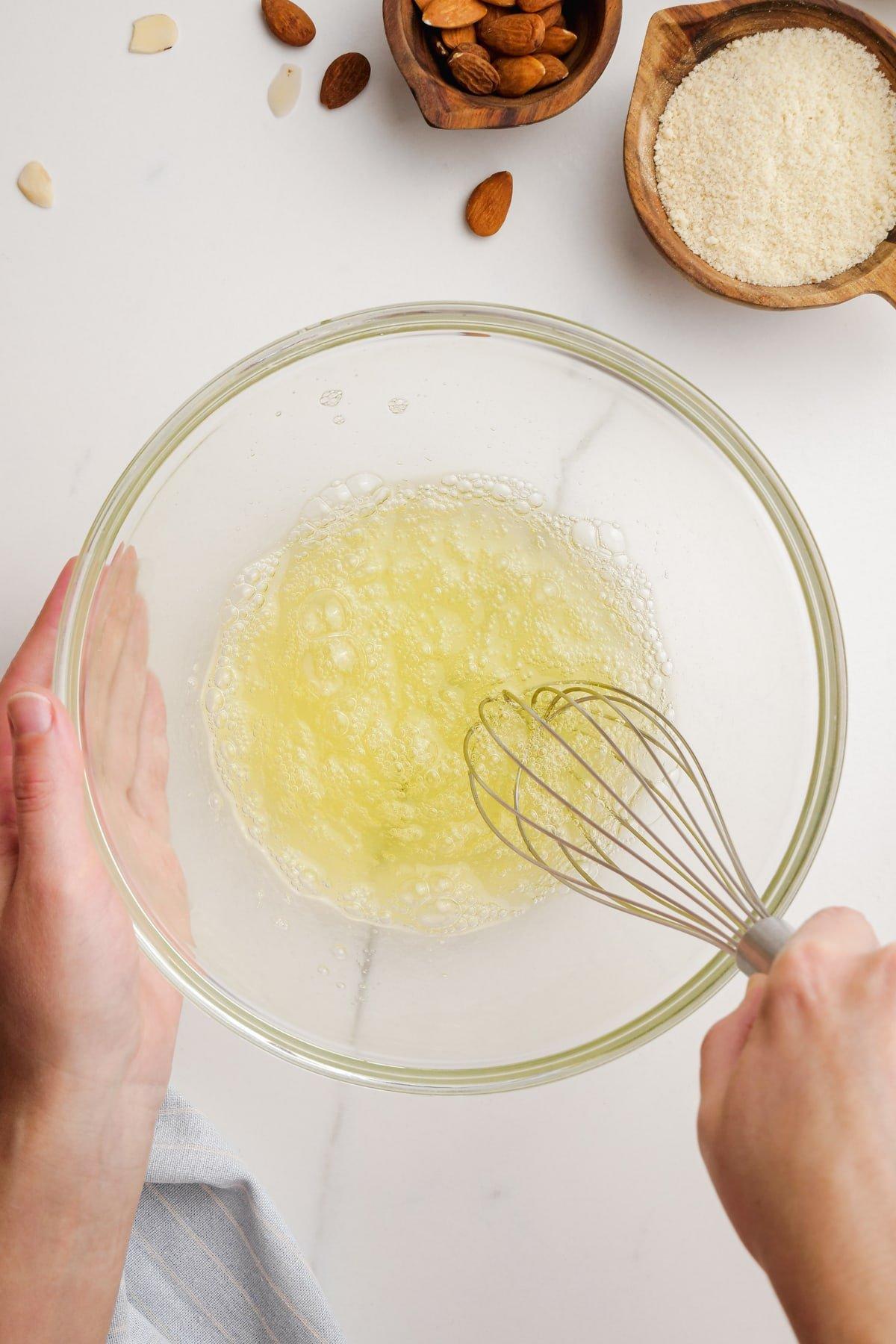 woman whisking egg whites in bowl