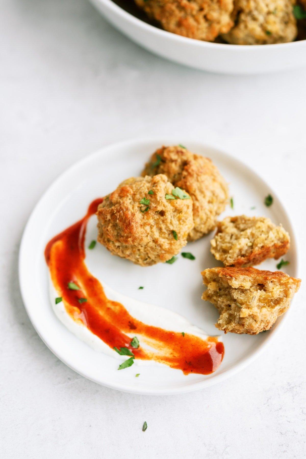 sausage balls on plate with sauce