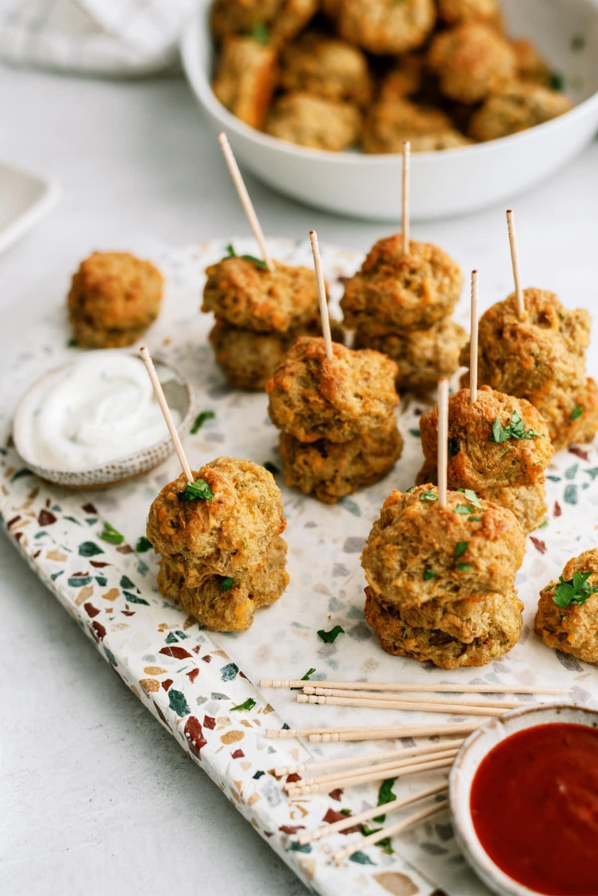 sausage balls on platter with dipping sauces