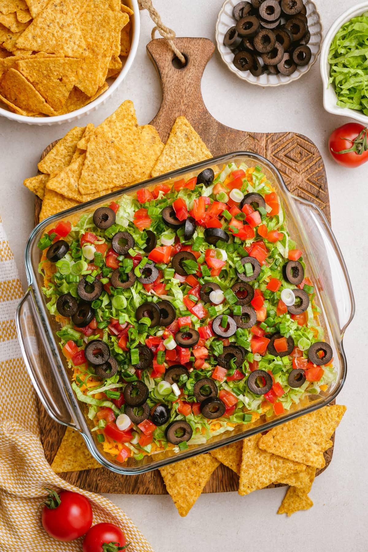 taco dip in casserole dish on tablescape