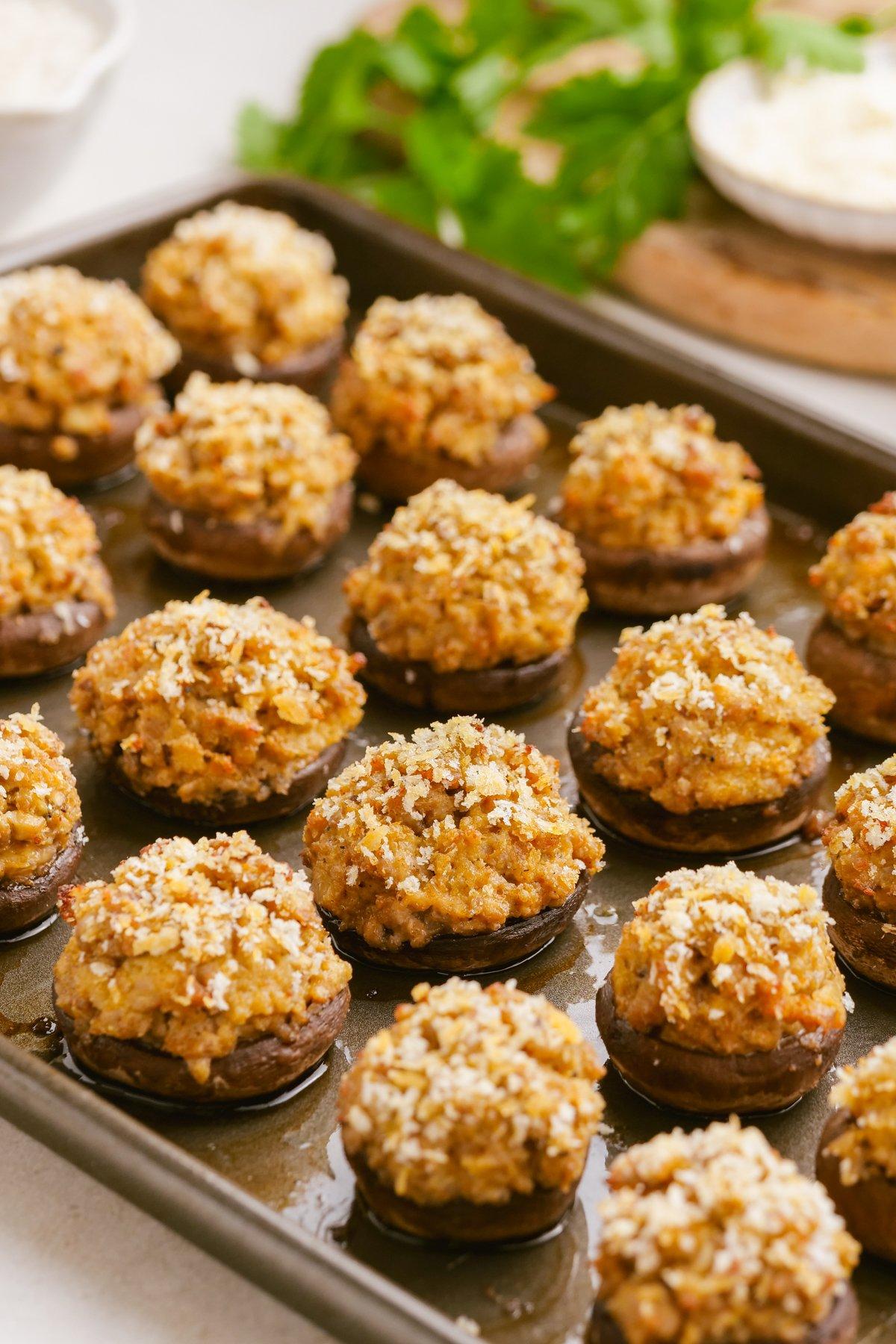 sausage stuffed mushrooms 14 cooked sausage-stuffed-mushrooms on baking sheet