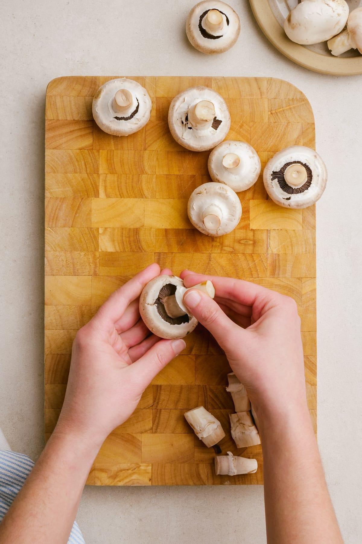 sausage stuffed mushrooms 2 woman removing stem from mushroom