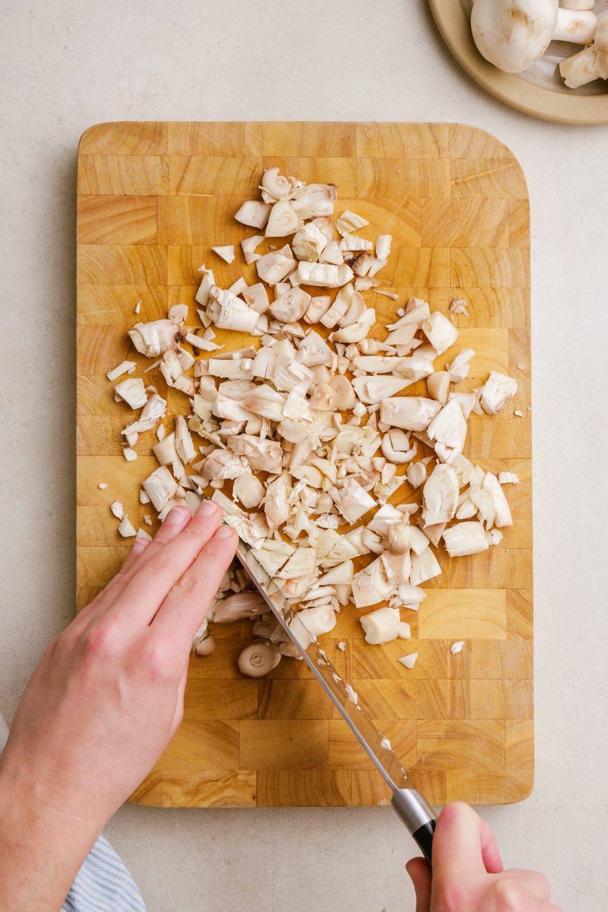 sausage stuffed mushrooms 3 woman chopping mushroom stems