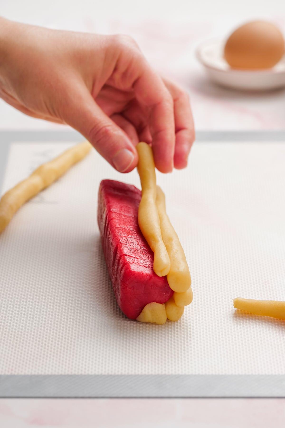 front view of dough snakes being applied to red heart stacks 