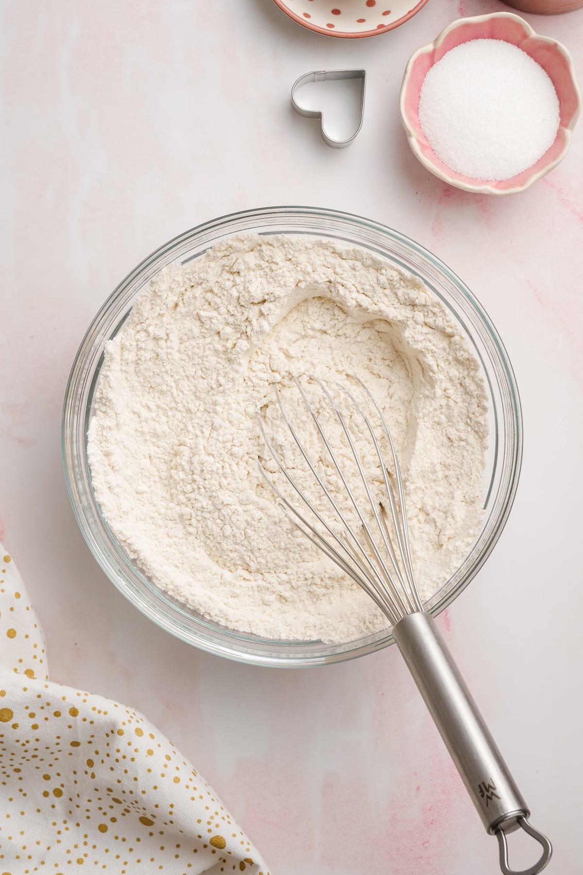 dry cookie ingredients in a bowl with whisk