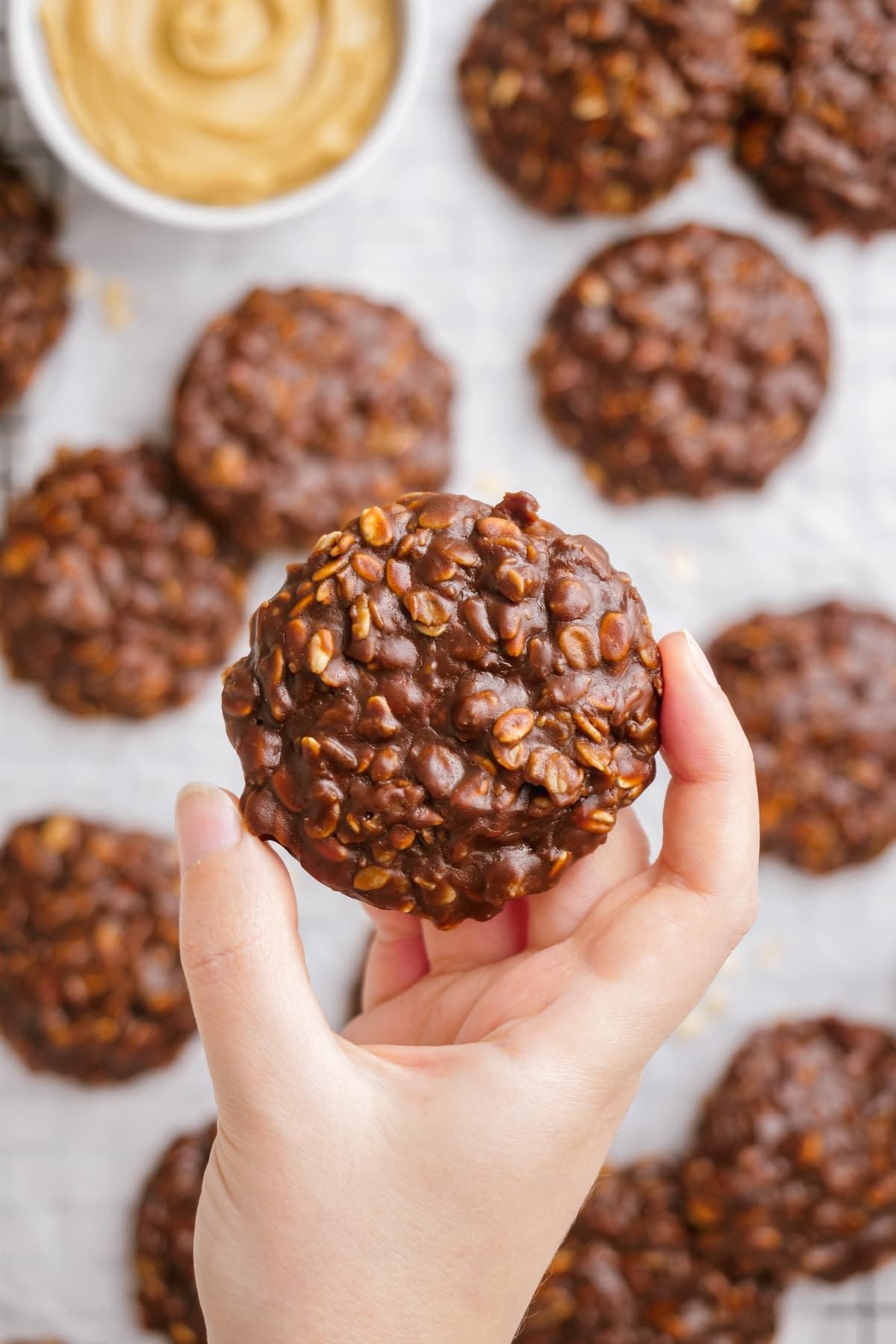 woman's hand holding a no bake cookie