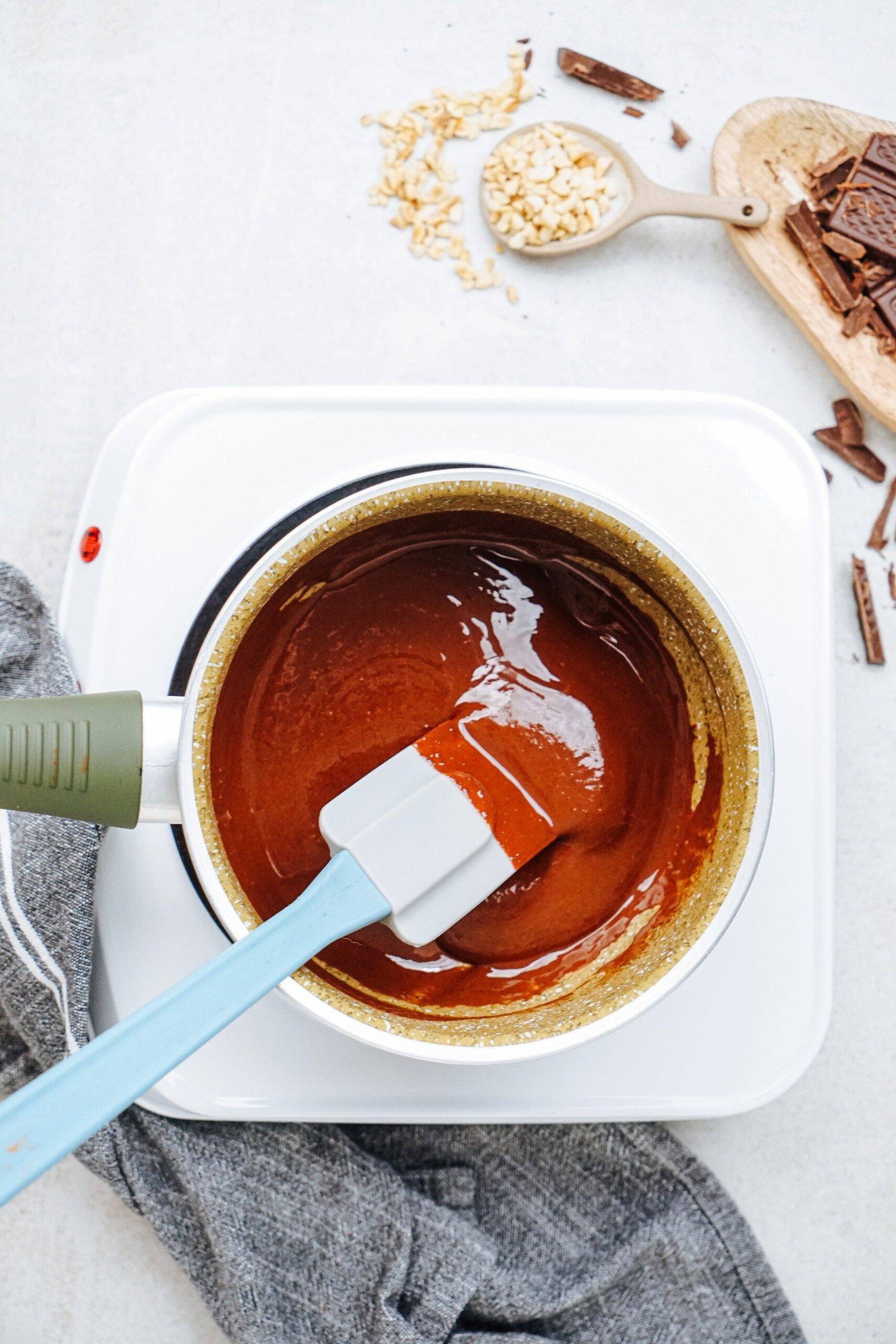 brownie bite ingredients   melted together in a pot with  spatula