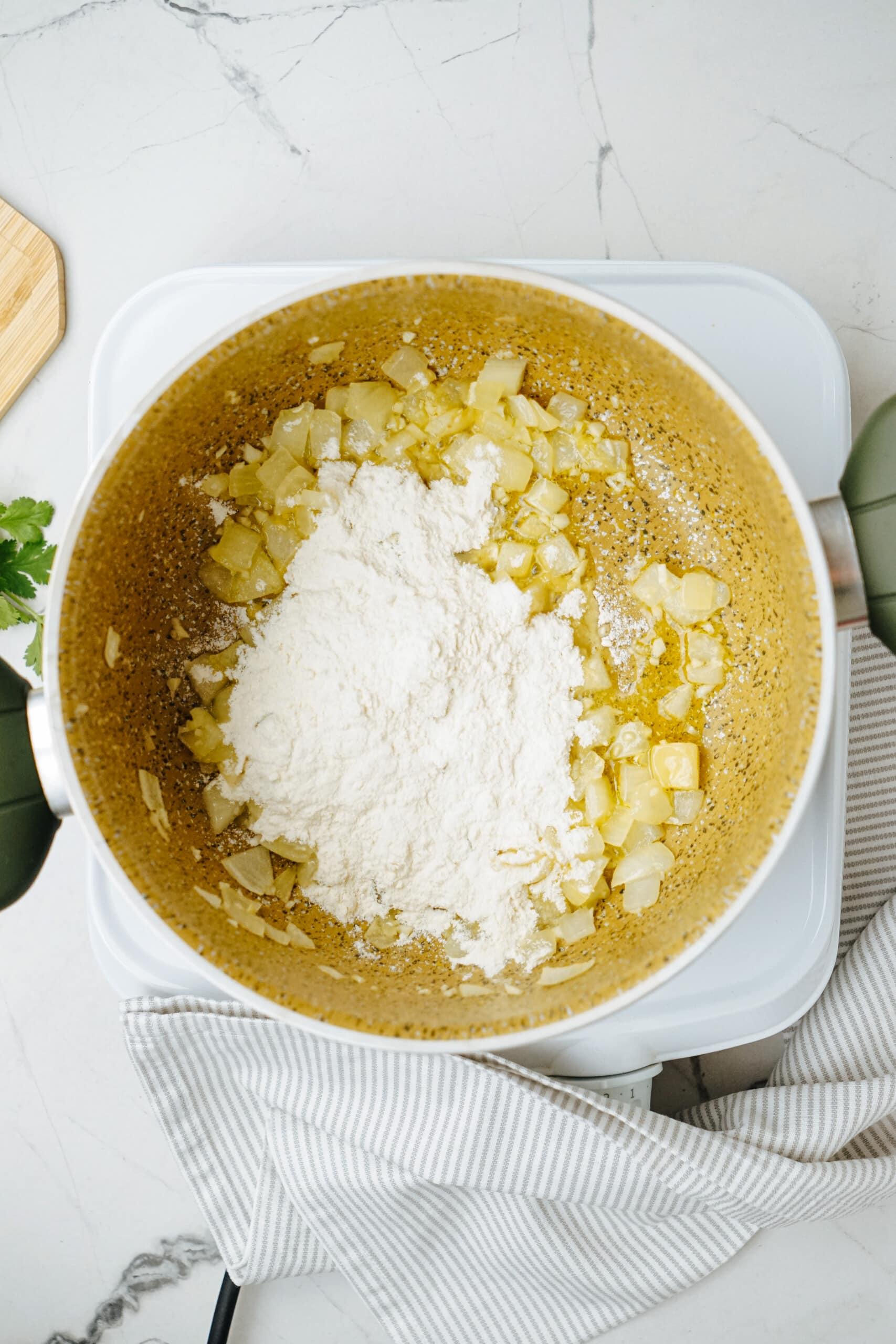 onions, garlic and flour in pot