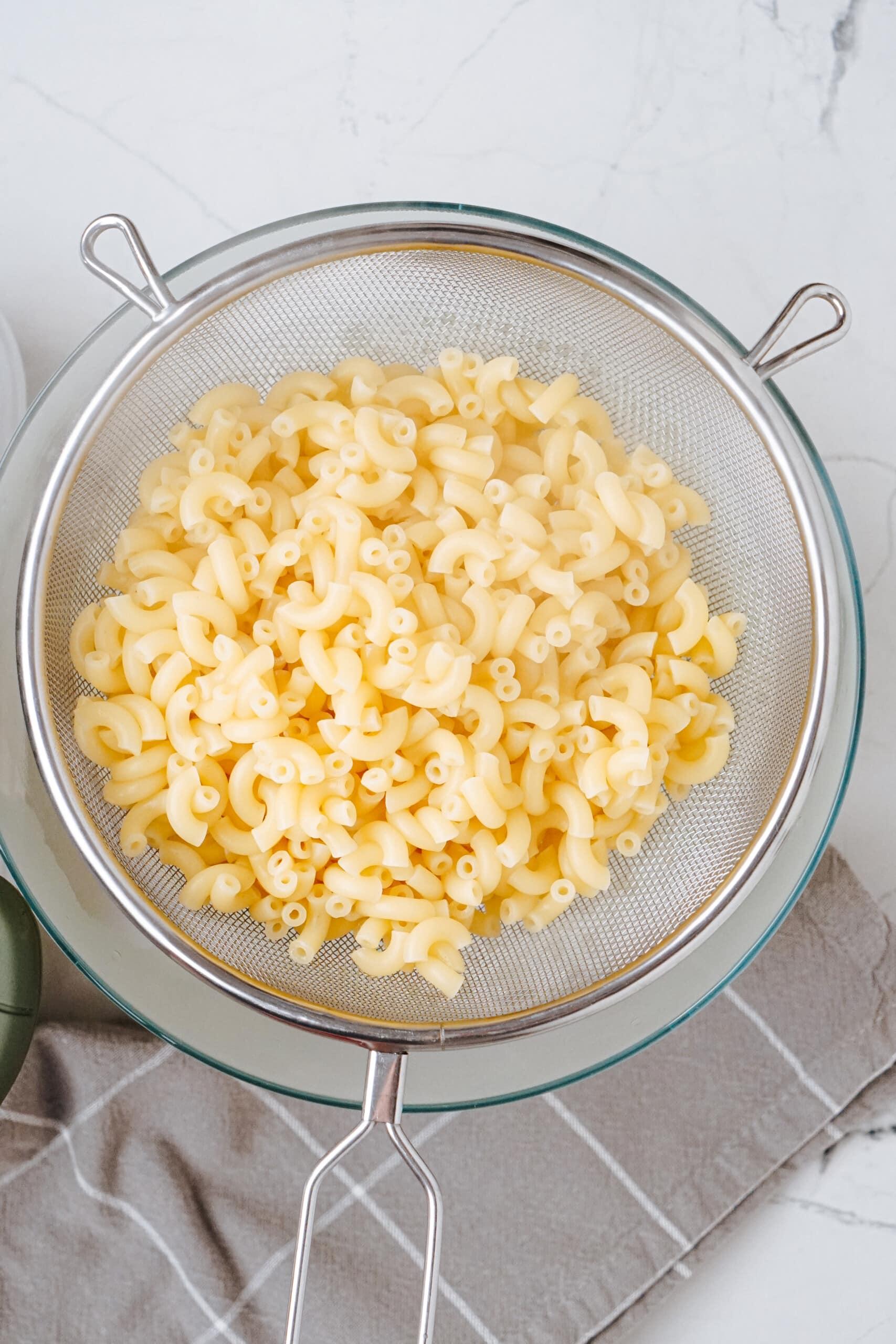 cooked macaroni in a strainer