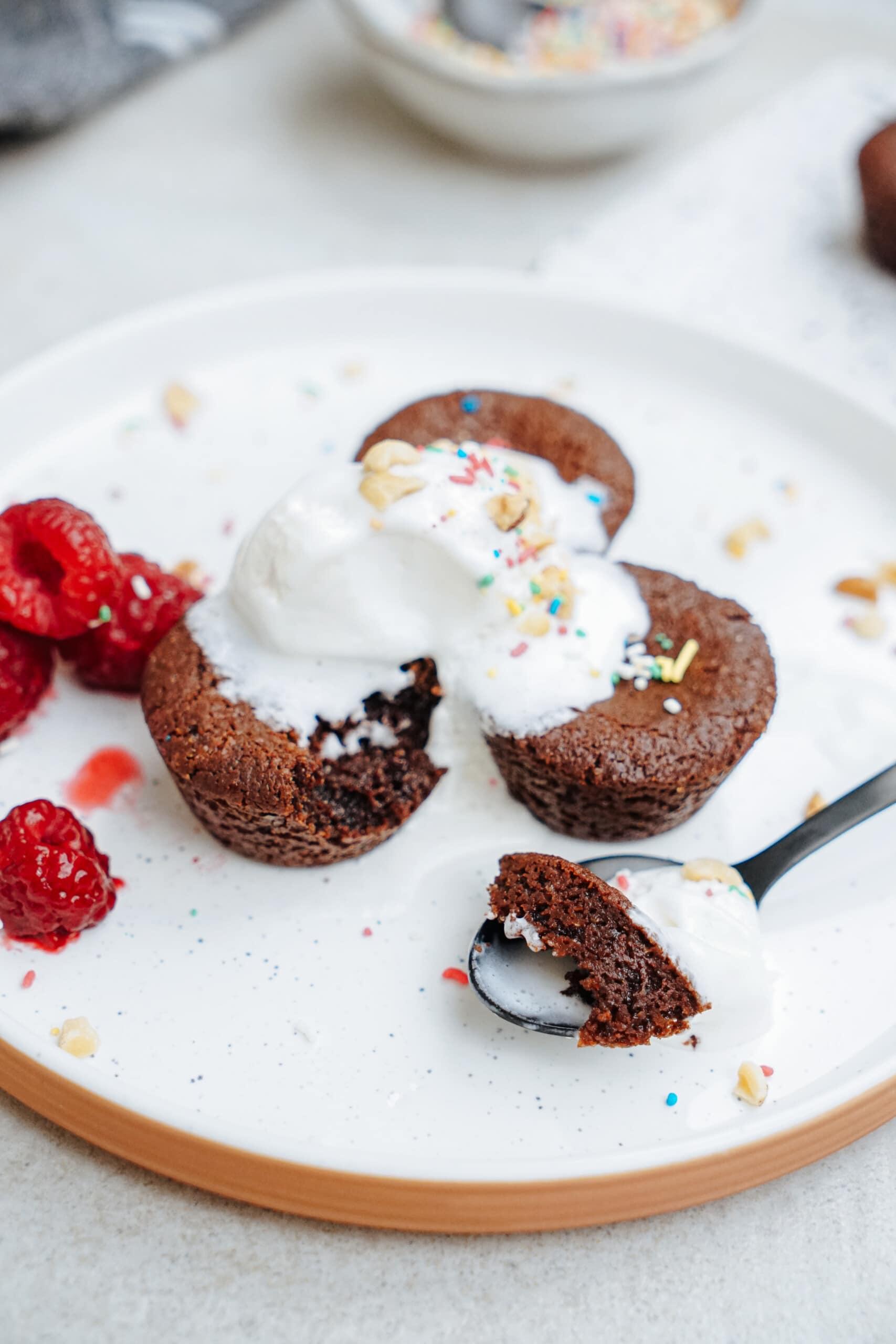 brownie bites with ice cream, sprinkles and raspberries on top