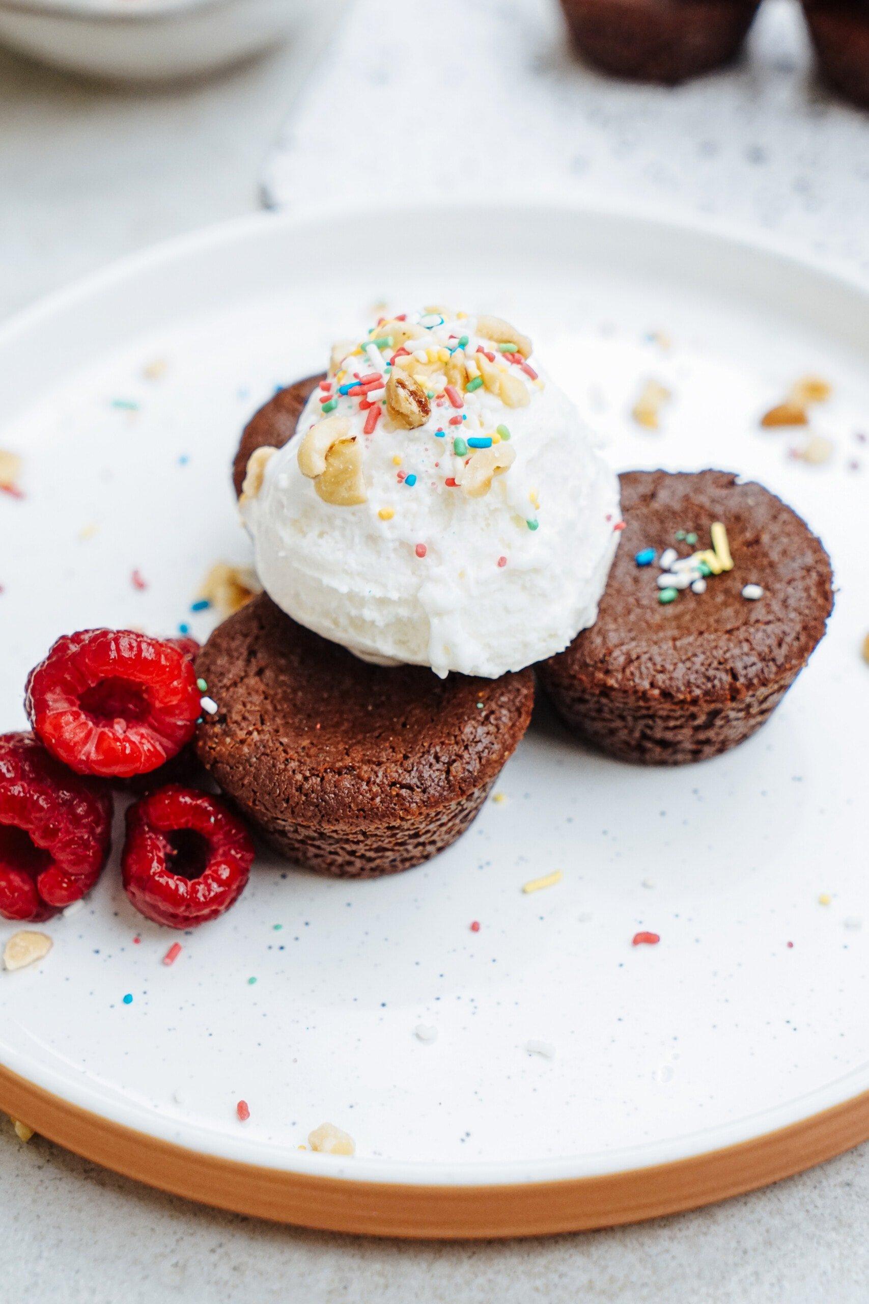 brownie bites with ice cream and raspberries on the side