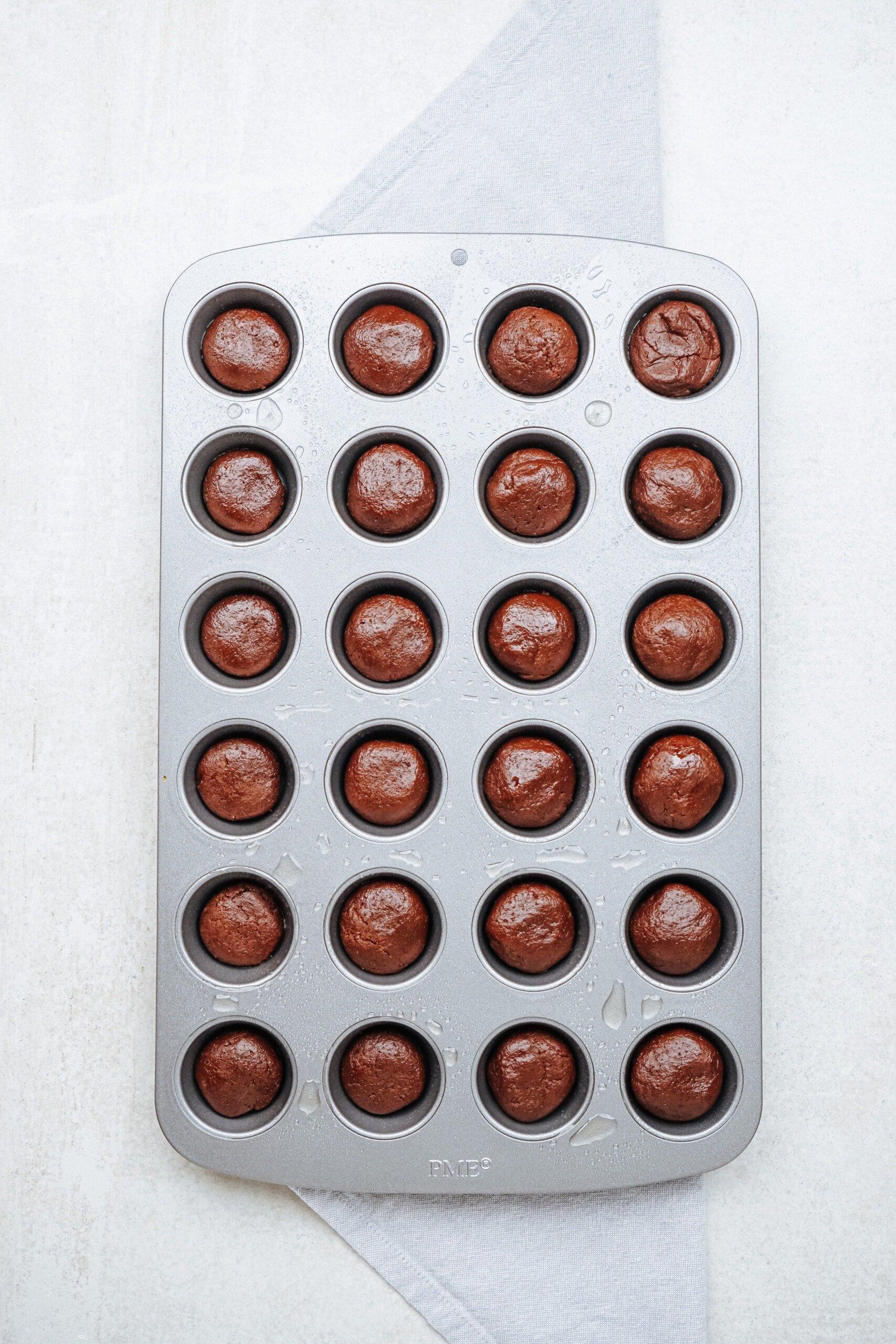 brownie batter in mini muffin tin