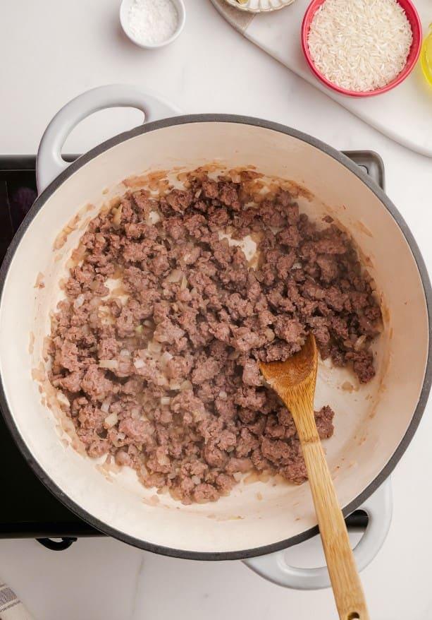 fried cabbage roll soup ingredients in pot with wooden spoon