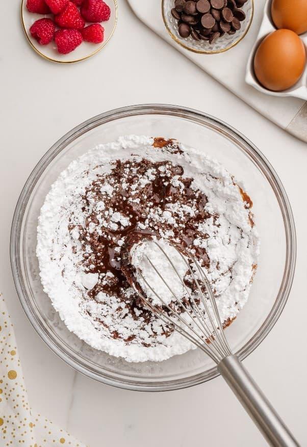 molten lava cake ingredients in glass bowl with whisk