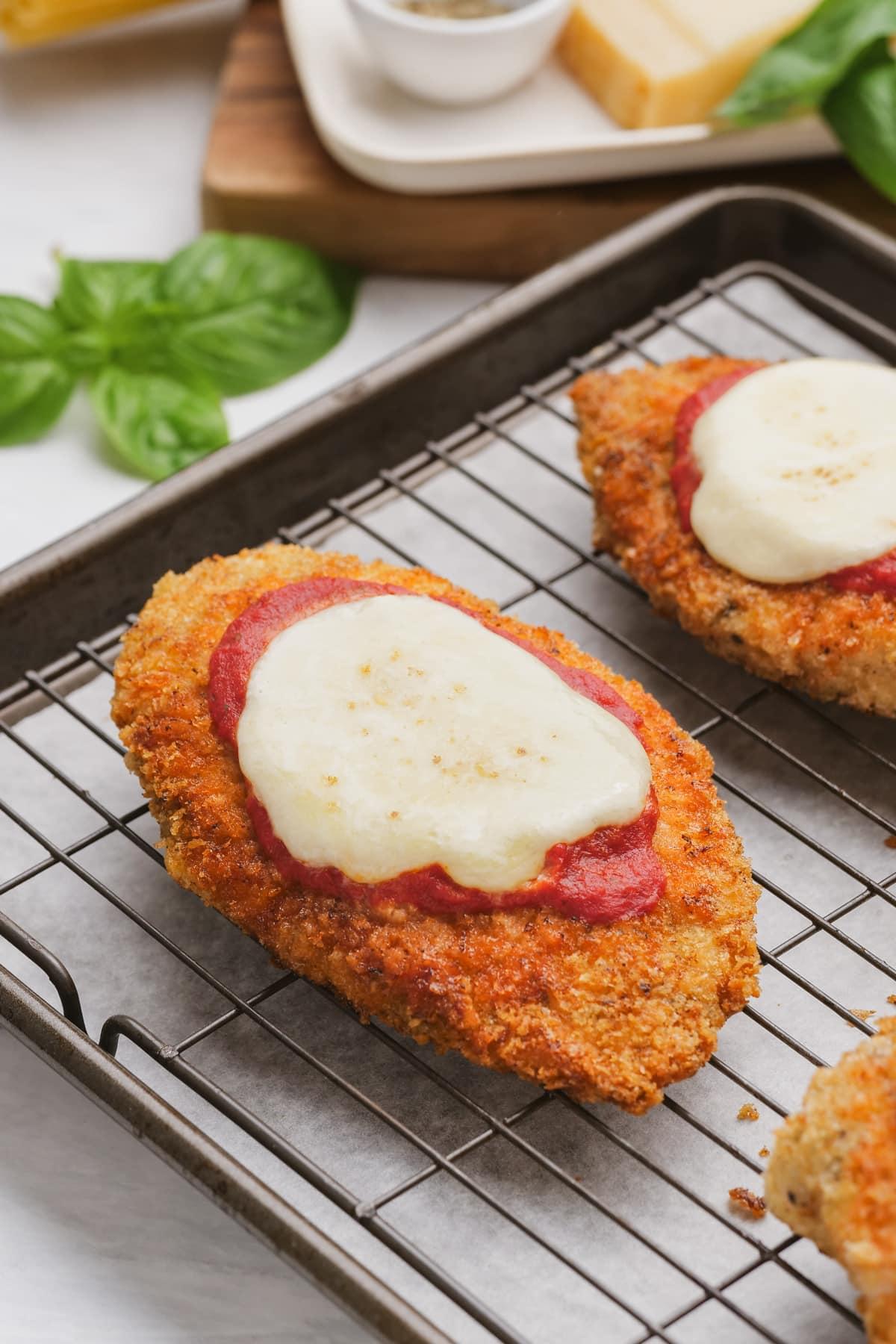 close up view of chicken parmesan on a cooling rack