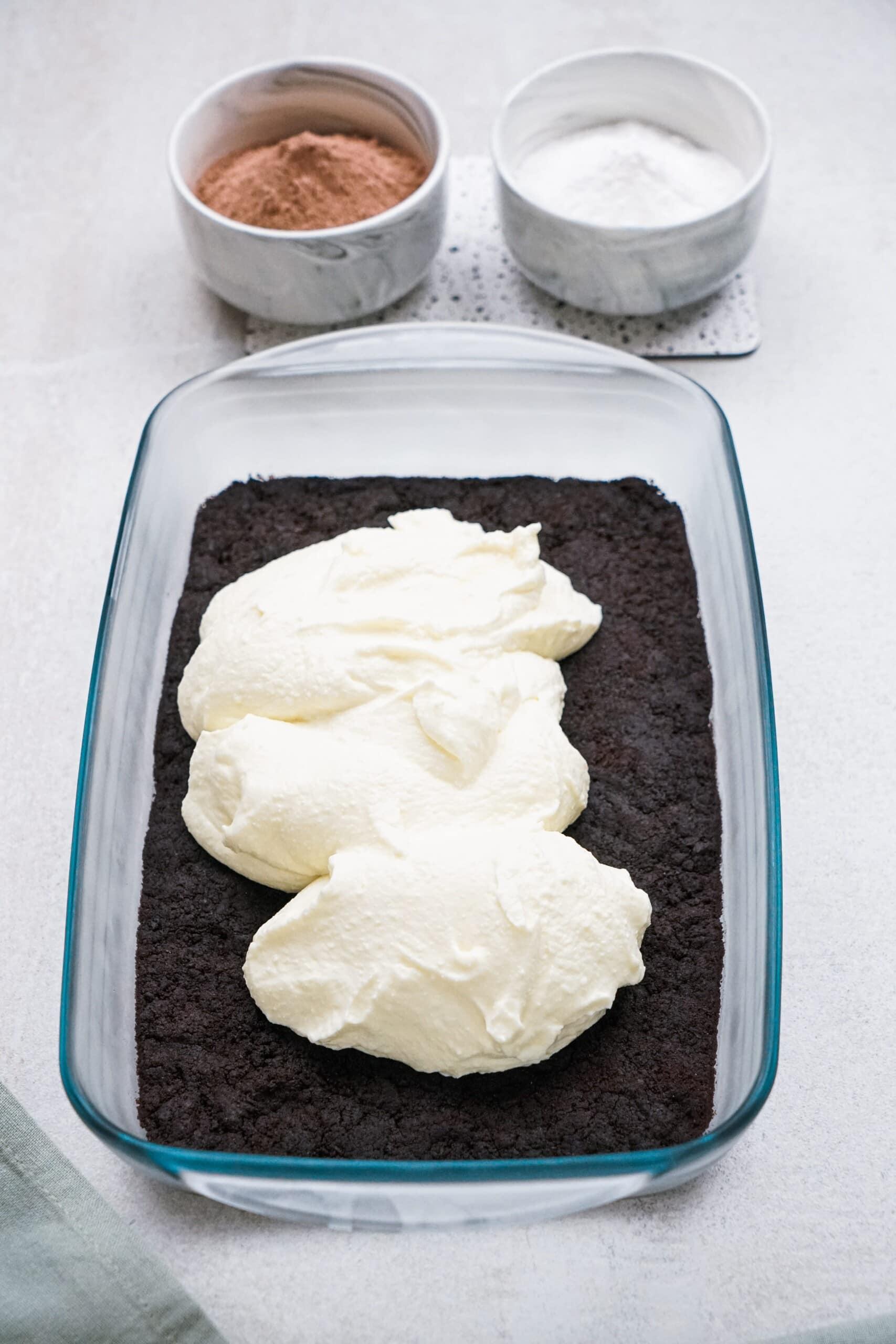 spreading cream cheese whipped cream mixture over oreo crust