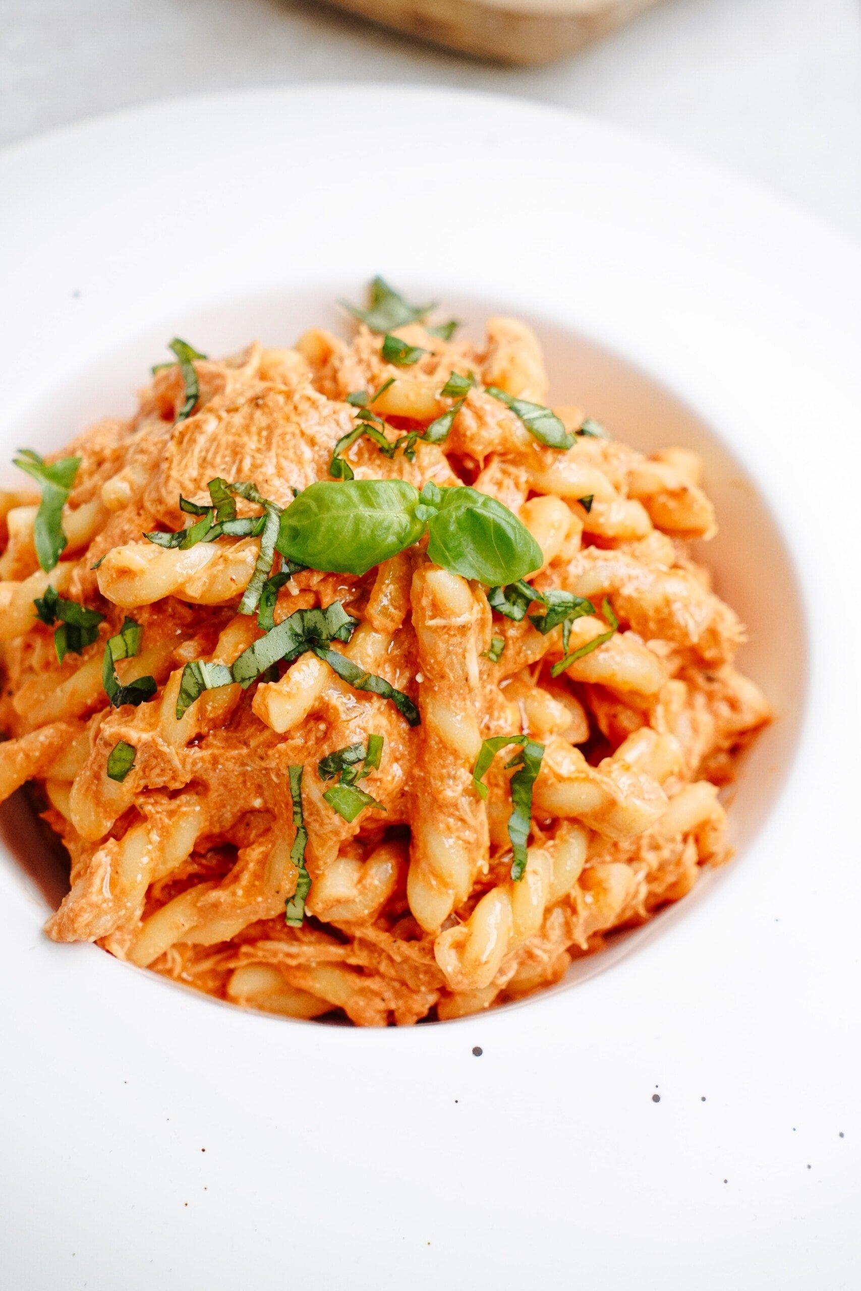 italian chicken pasta with garnish on top in a bowl