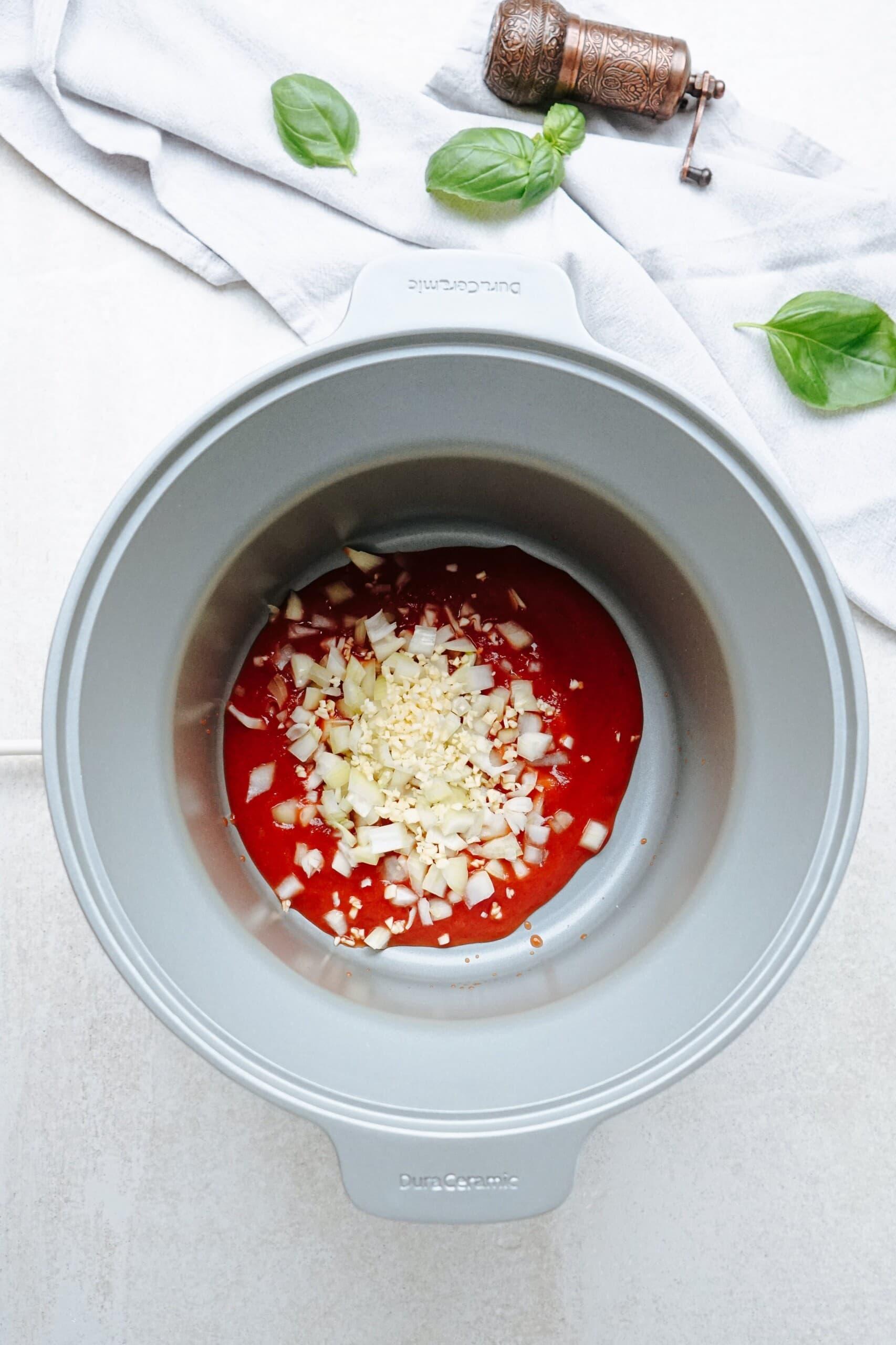 marinara sauce and diced onions in crockpot