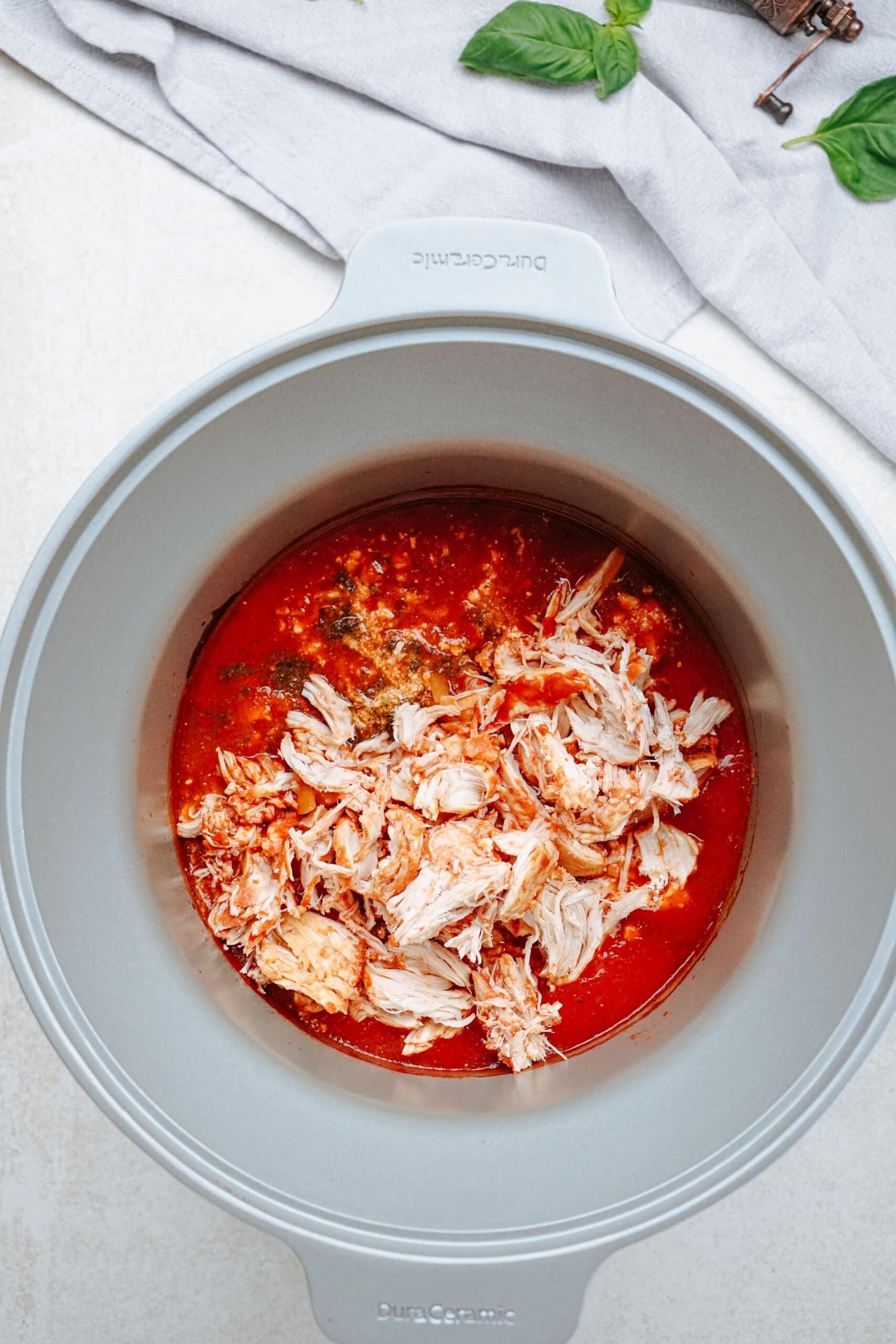 shredded chicken in a crockpot with marinara sauce