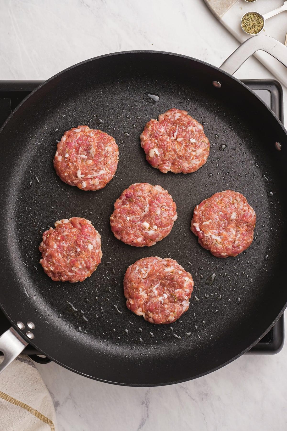 breakfast sausage frying in a pan