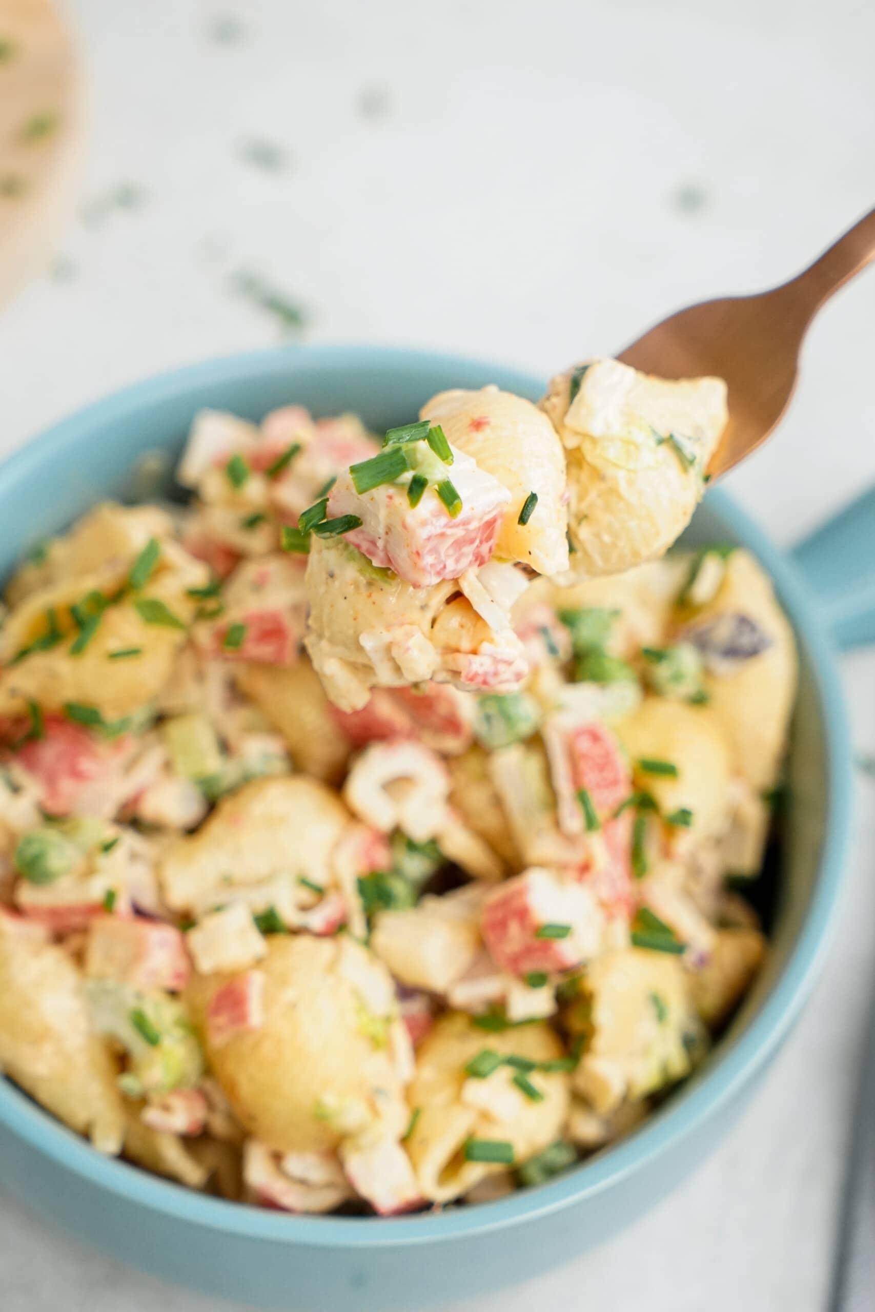 seafood pasta salad close up on a fork