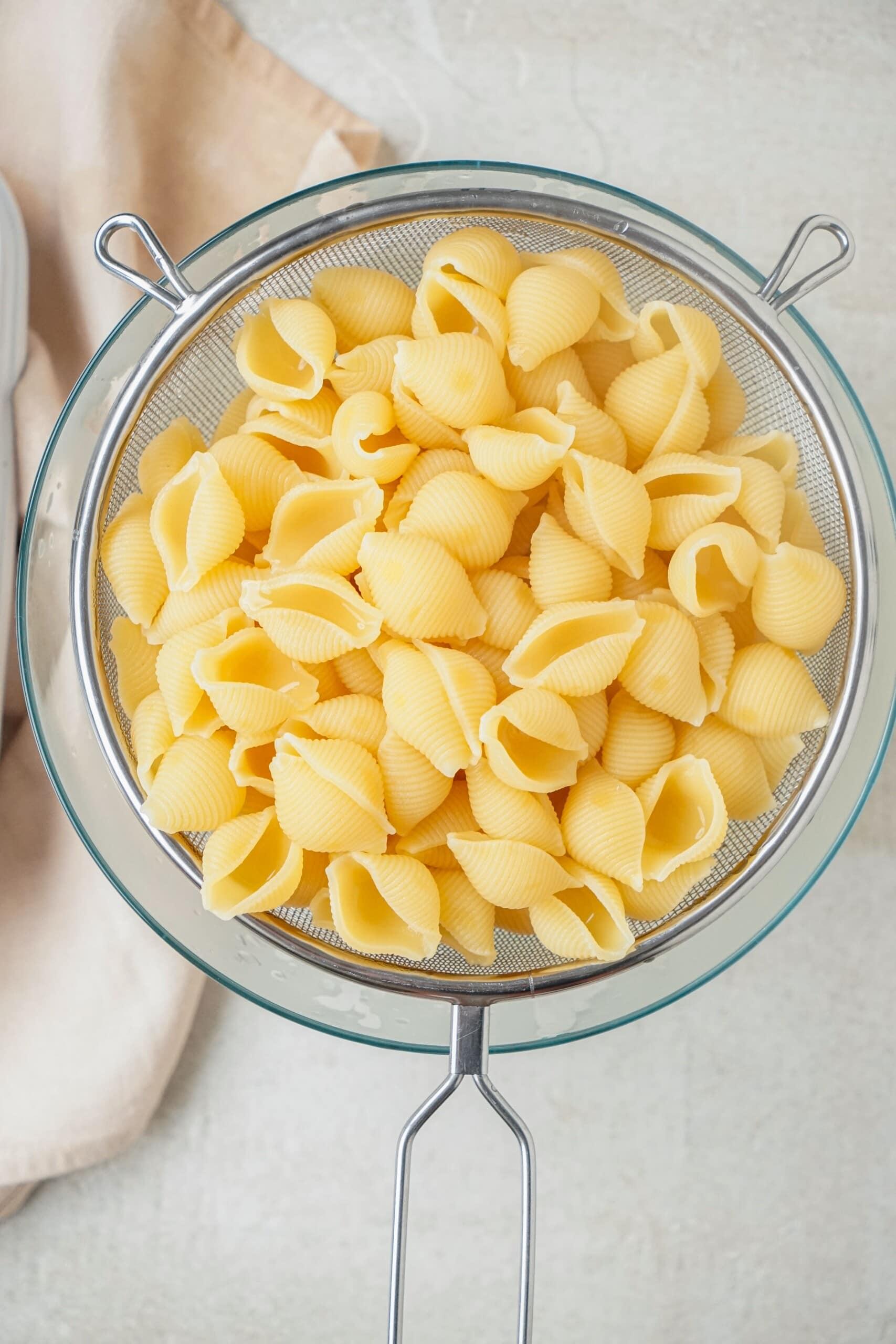 cooked pasta shells in a colander