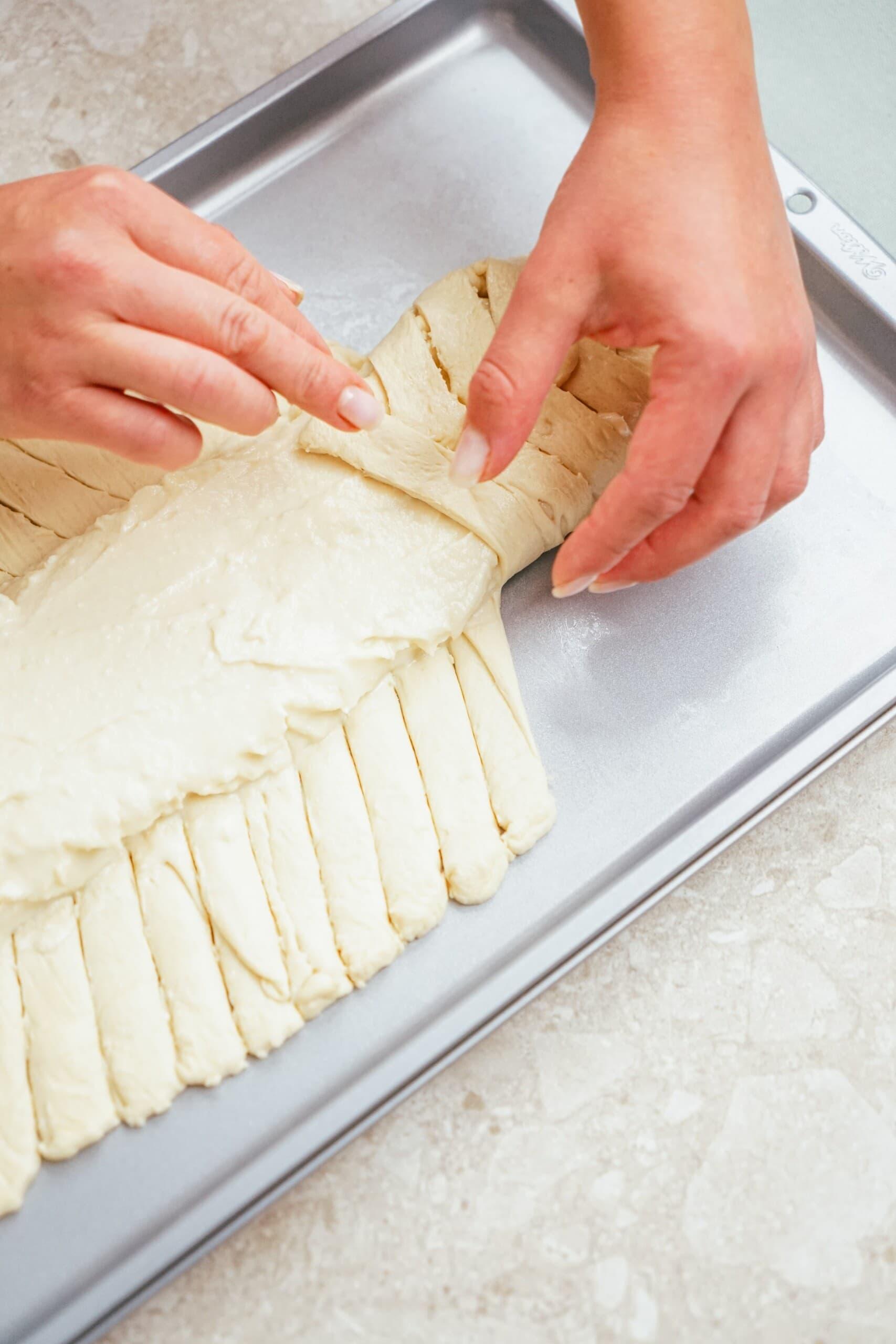 woman's hands criss crossing the cut pieces towards the center